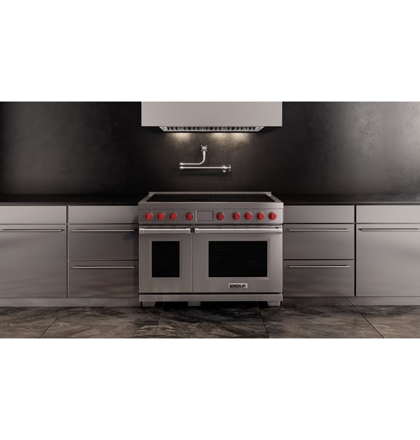 Wolf Professional Induction Range with stainless accent oven door shown here with a Wolf Professional Hood Liner in a minimalist  kitchen design featuring matching stainless kitchen cabinet handles.