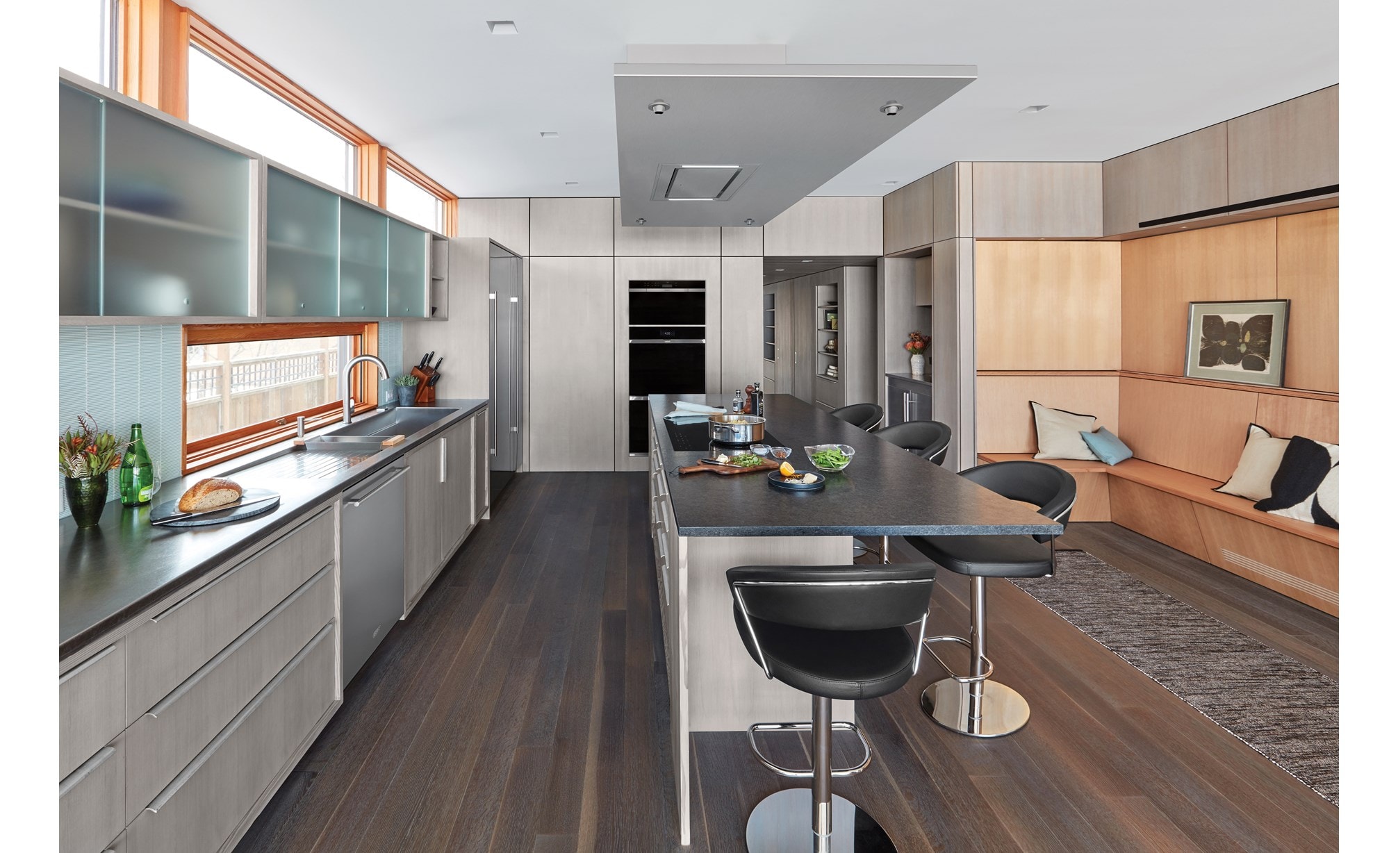 Wolf 36" Ceiling Mounted Hood Stainless Steel (VC36S) shown blending seamlessly above large kitchen island in modern minimalist kitchen