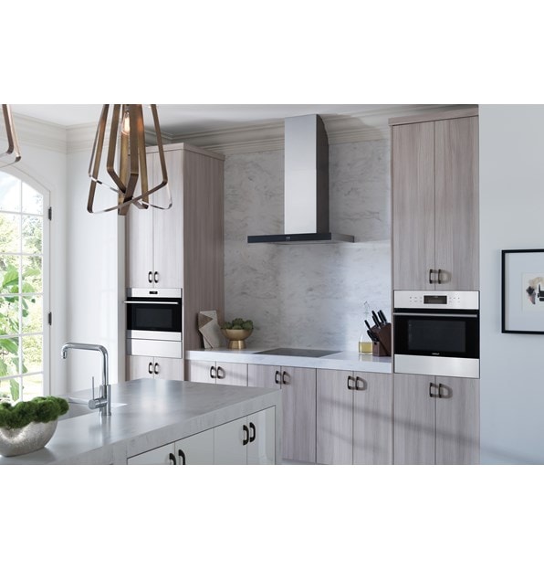 The Wolf 30" Cooktop Wall Hood - Black (VW30B) with Wolf 24" Contemporary Induction Cooktop (CI243C/B) shown in a bright airy kitchen