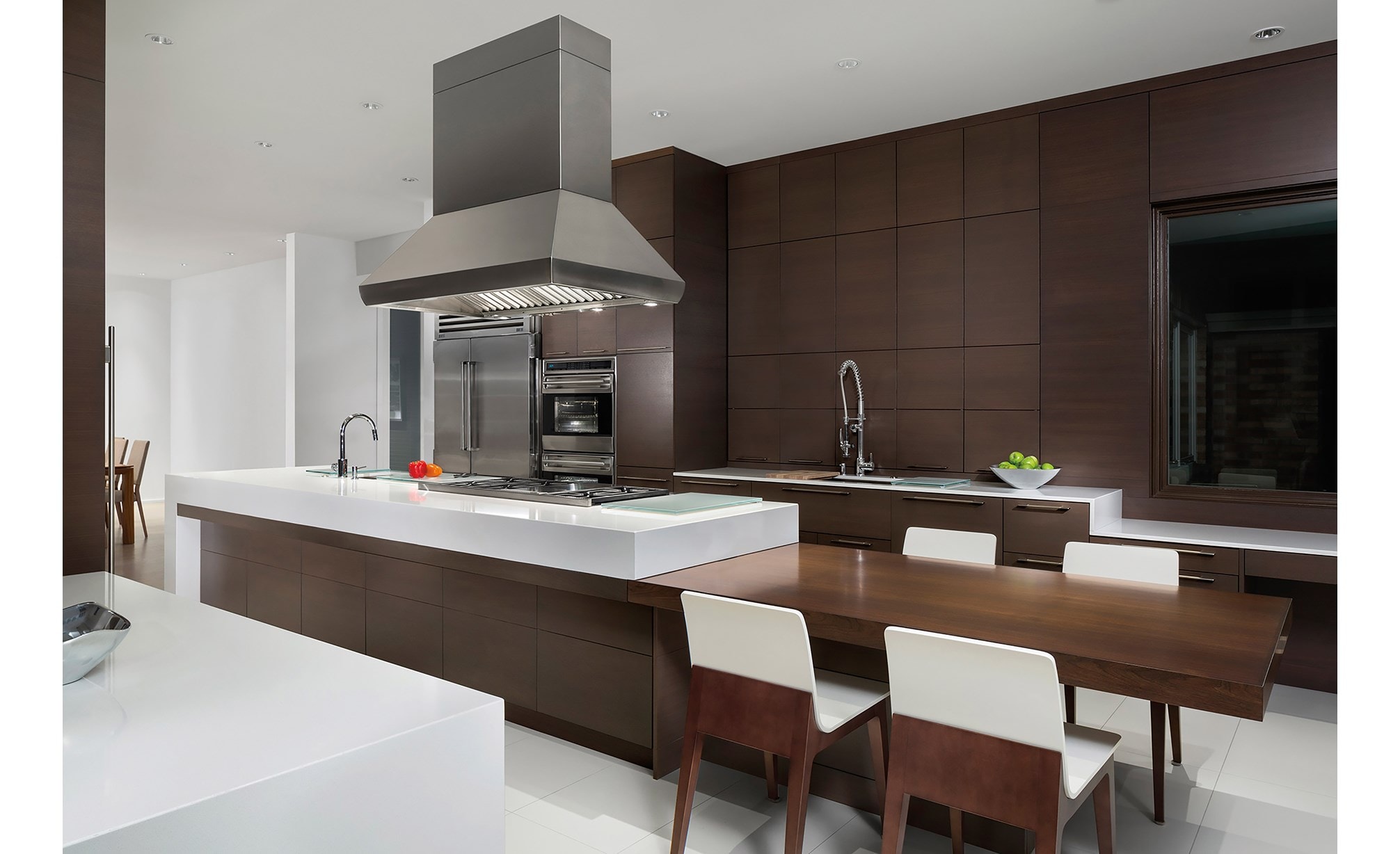 The Wolf 54" Pro Island Hood (PI543418) displayed above 48" Sealed Burner Rangetop (SRT486G) in large ultra-modern panel kitchen design