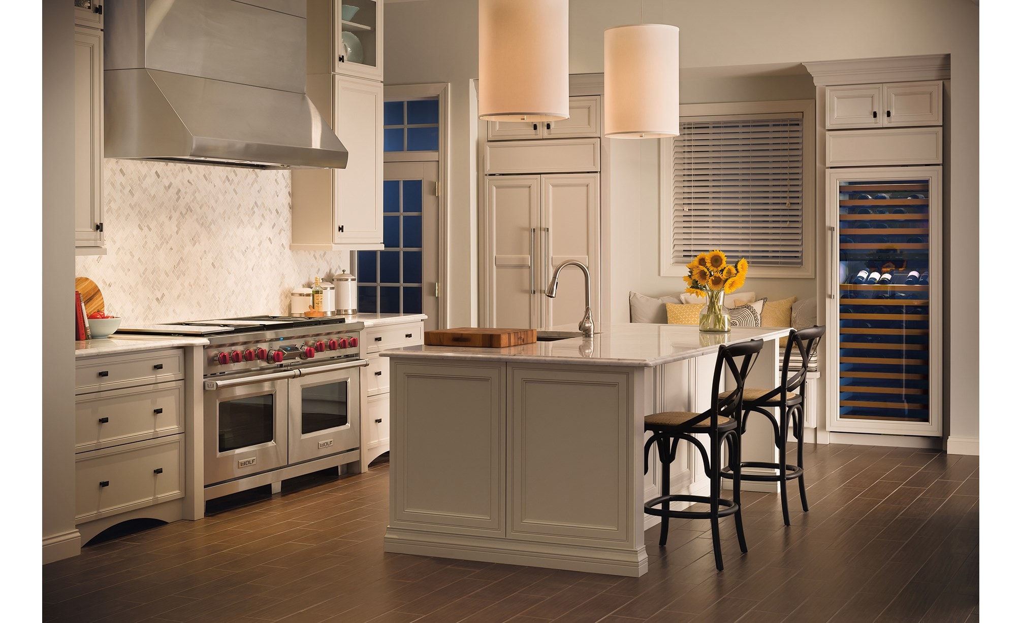 Wolf 60" Pro Wall Hood 24" Depth (PW602418) is a timeless beauty in this elegant French inspired kitchen using white cabinets and marble countertop