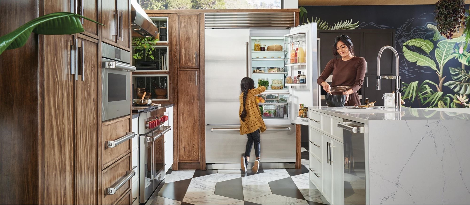 Mother and daughter in a kitchen equipped with a Sub-Zero fridge