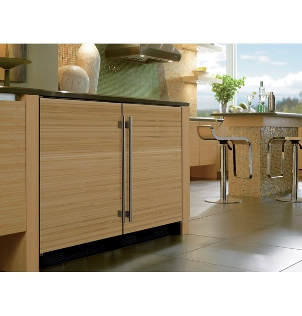 The Sub-Zero 24" Undercounter Refrigerator Freezer Panel Ready (UC- 24R) featuring custom solid wood panel with stainless steel handle.