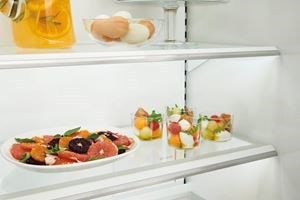 Close up view of Sub-Zero Classic Series Full Size Refrigerator's LED lit  custom shelves