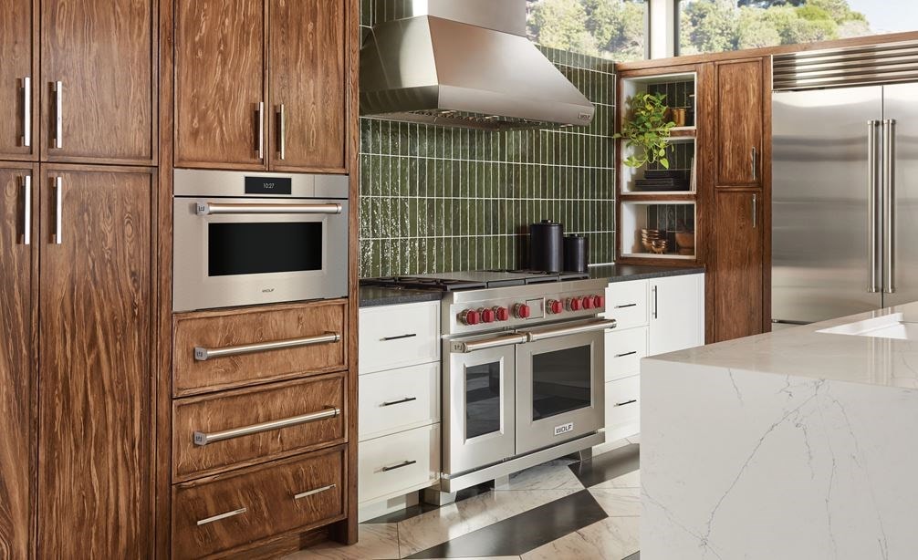 Wolf 30&quot; M Series Professional Convection Steam Oven (CSO3050PM/S/P) displayed alongside Provincial stained birch cabinets and botanical green kitchen backsplash