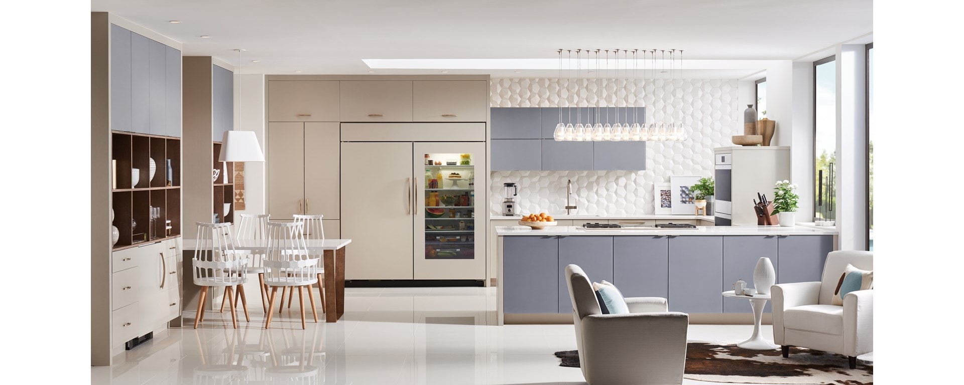 Elegant kitchen design featuring Sub-Zero Classic Series Refrigerator, Wolf Downdraft Ventilation, Wolf M Series Ovens and Module Cooktops all enclosed in custom panels