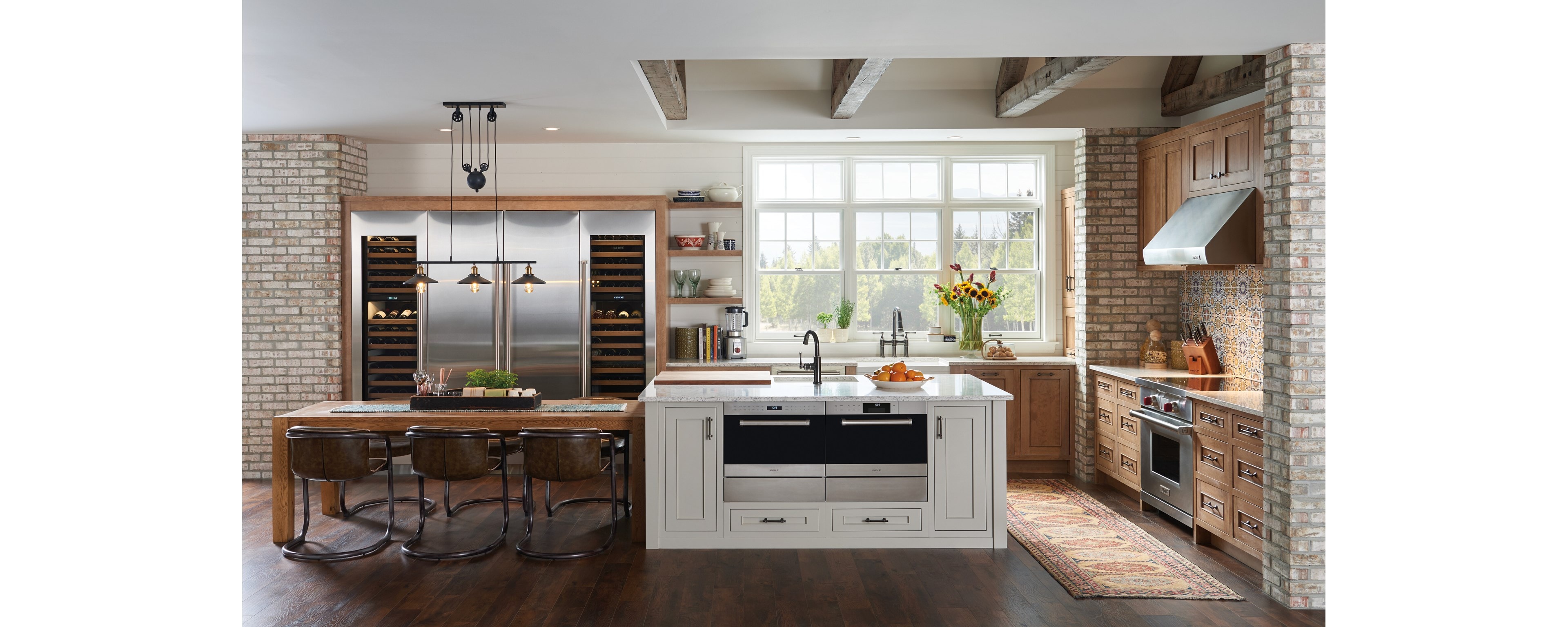 Nordic farmhouse kitchen design featuring Sub-Zero Designer Series Refrigerator and Wine Storage unit with Wolf Induction Range, Microwave Oven and Ventilation Hood