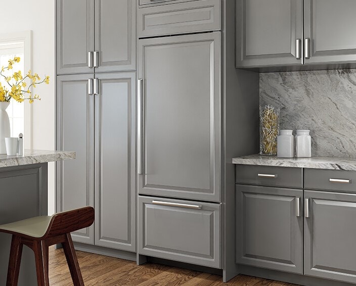 Sub-Zero Classic Over-and-Under Refrigerator Freezer with custom panel door.