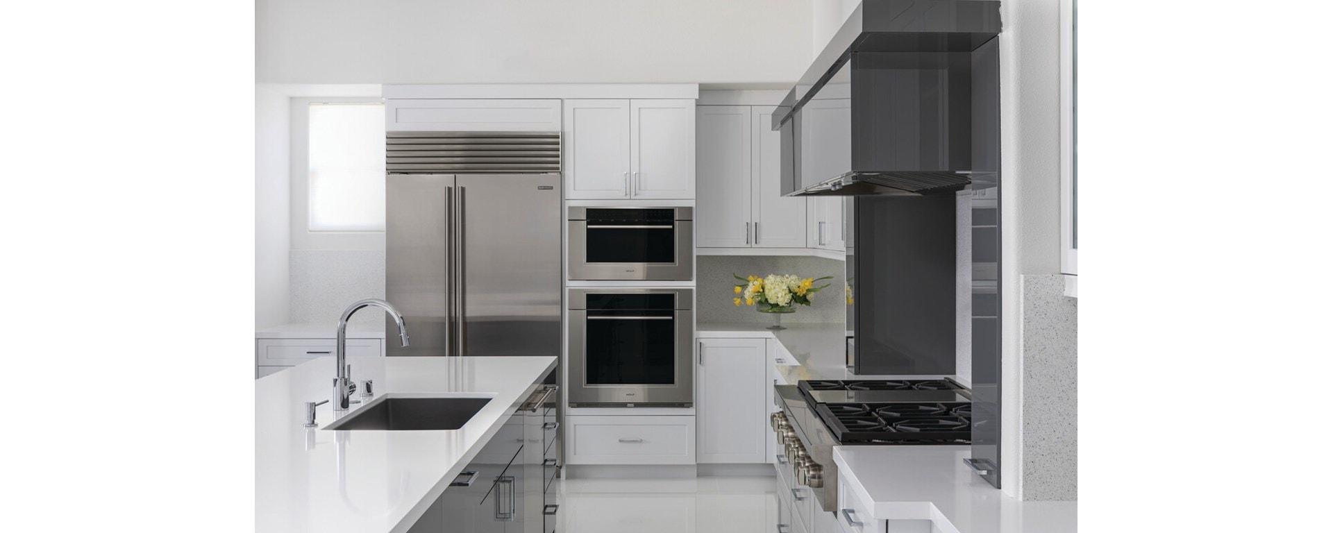 Clean, minimalist kitchen design featuring Sub-Zero Classic Series Refrigerator, Cove Dishwasher, Wolf M Series Oven, Sealed Burner Rangetop and Wolf Speed Oven
