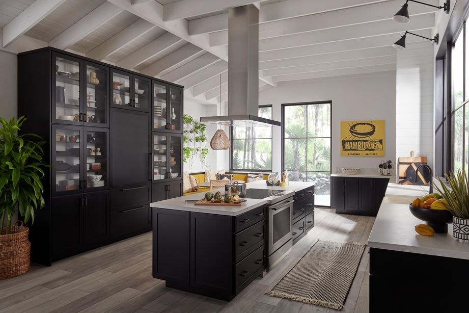 Wolf 36&34; Induction Range (IR36550/S/T) shown in large open and bright kitchen space featuring warm wood floors, shiplap and white ceiling beams.