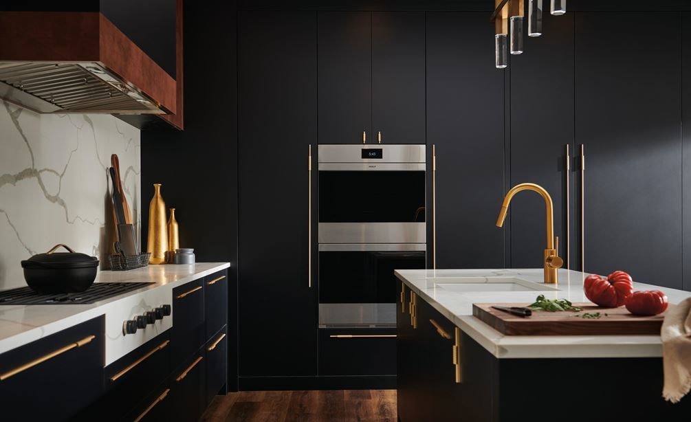 Wolf M Series Ovens and Wolf Contemporary Gas Cooktop shown in upscale luxury kitchen featuring seamless dark blue cabinetry
