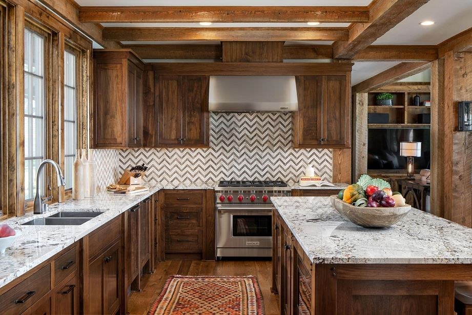Wolf 36&34; Gas Range (GR366) and Wolf 36&34; Professional Wall Hood (PW362418) shown in custom kitchen design featuring warm wood cabinets, wood beams and wave patterned tile backsplash.