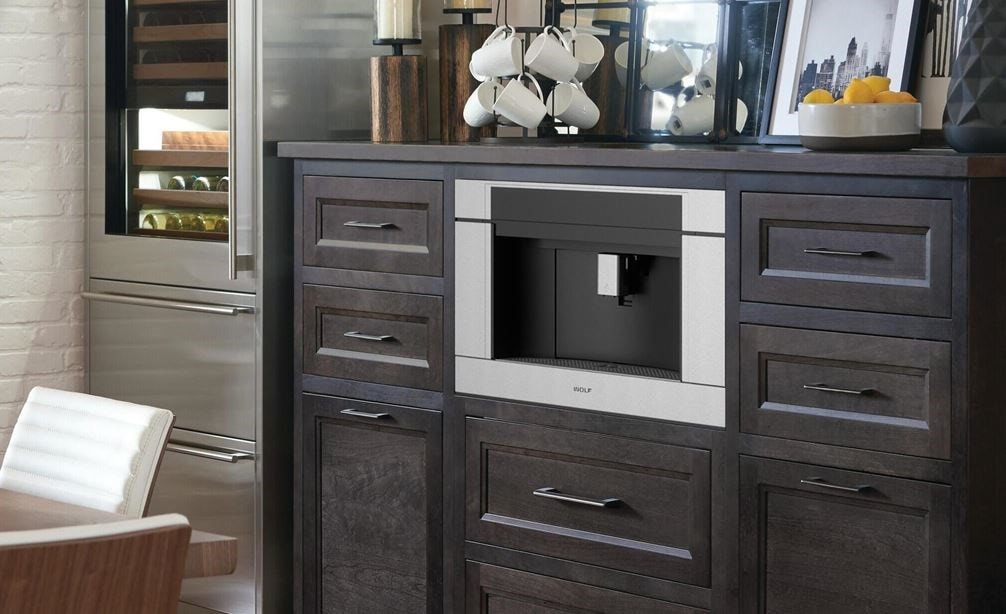 The Wolf 24&quot; Coffee System Black Glass (EC24/B) shown set in a rustic pantry-style coffee station conveniently located in dining room
