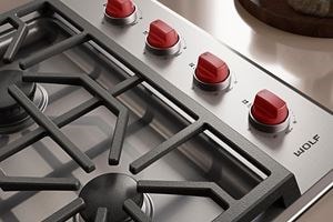 Wolf M Series 30" Gas Cooktop (Professional) shown with iconic red knobs