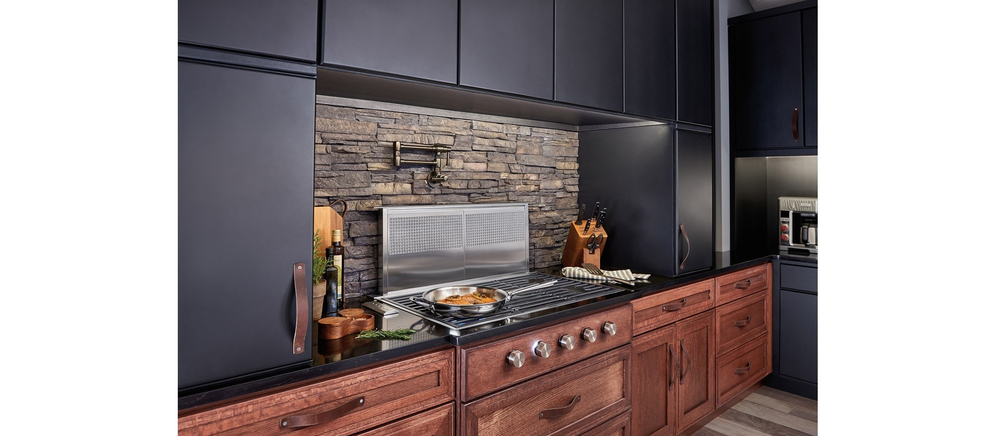 Wolf 36" Contemporary Gas Cooktop 5 Burner (CG365C/S) shown in an array of rich textures including brick backsplash and dark cabinetry