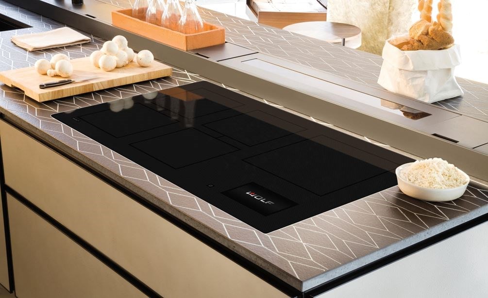 Wolf 36 Contemporary Induction Cooktop (CI36560C/B) show set flush in custom kitchen countertops featuring continuous symetrical pattern.