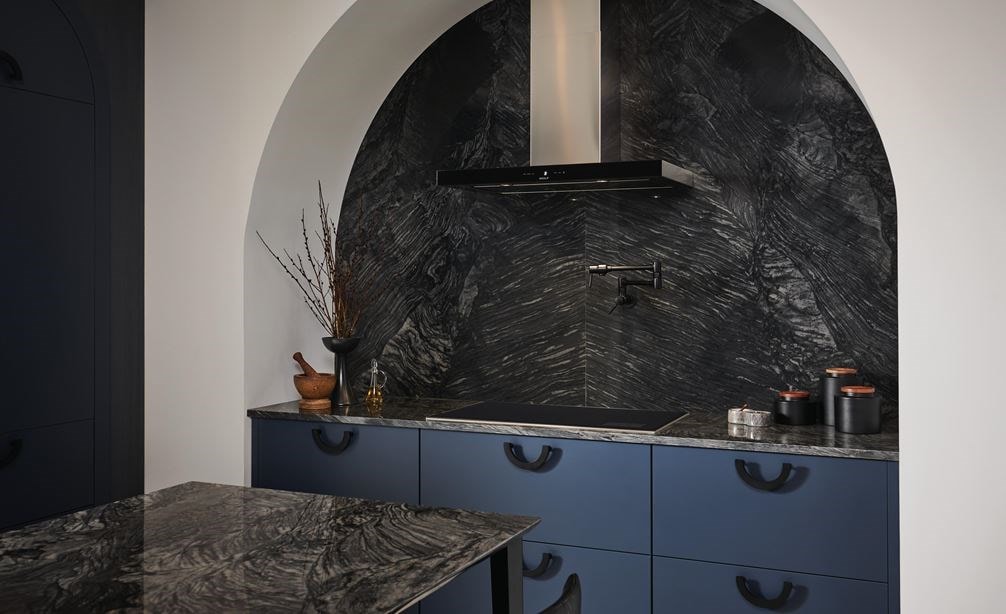 Wolf 36" Transitional Induction Cooktop (CI36560T/S) featured in marble arch cooking enclosure with blue cabinet drawers. 