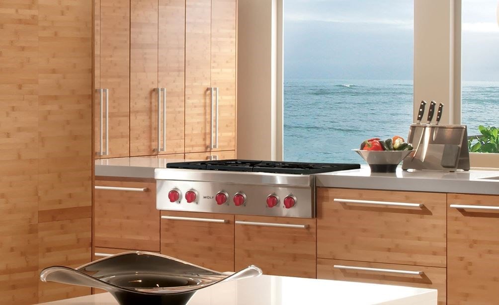 The Wolf 36&quot; Sealed 4 Burner Rangetop and Infrared Griddle (SRT364G) featured in a large modern eat-in kitchen.