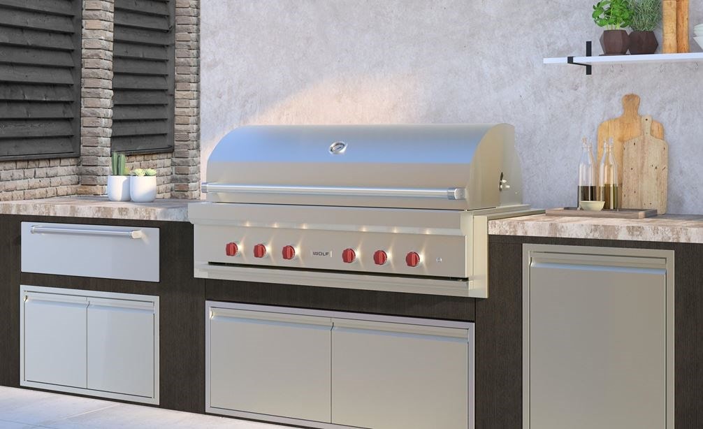 The Wolf 54" Outdoor Gas Grill (OG54) shown in a luxury outdoor kitchen featuring professional grade Wolf Outdoor Kitchen appliances.