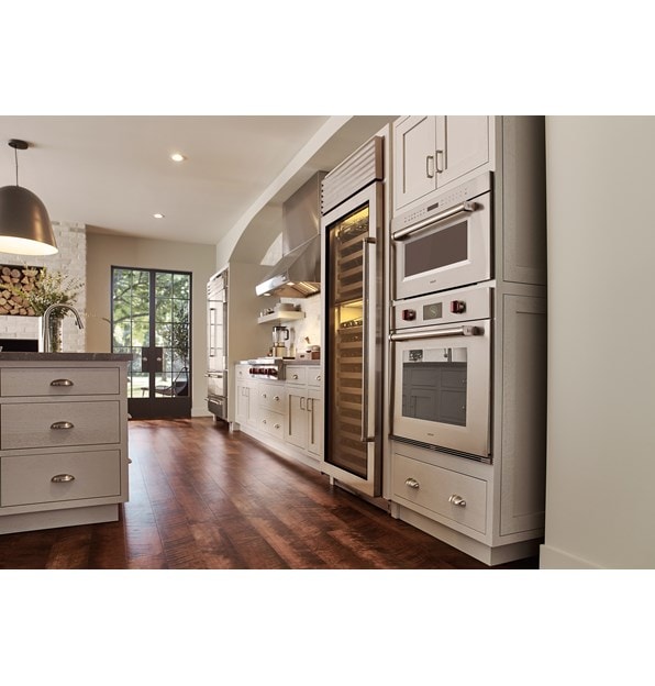 Wolf 30" M series Professional Drop-Down Door Microwave Oven (MDD30PM/S/PH) displayed in a classic medium tone wood floor kitchen design