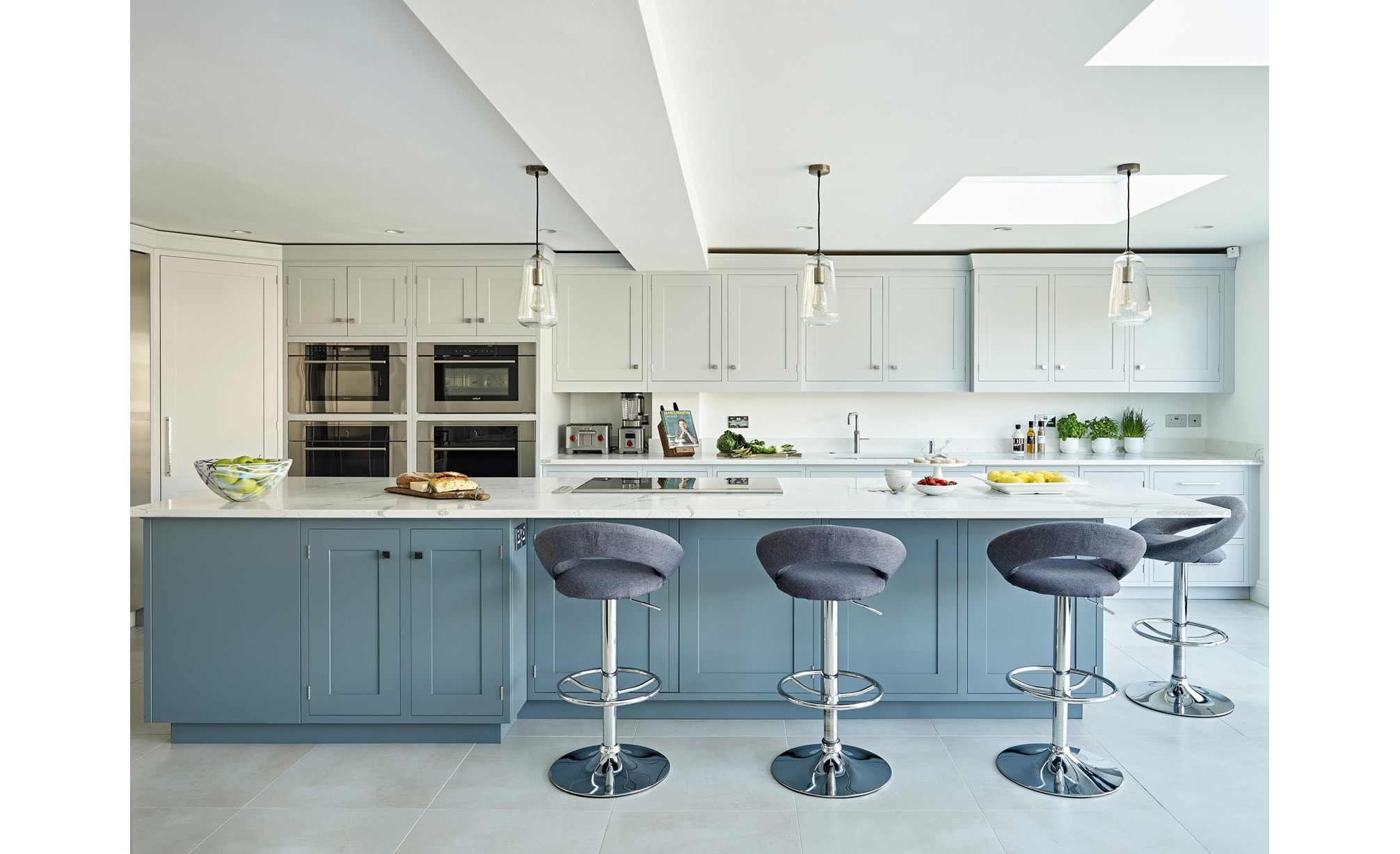 Wolf 30" M Series Transitional Drop-Down Door Microwave Oven (MDD30TM/S/TH) in classic white design featuring huge eat-in kitchen island