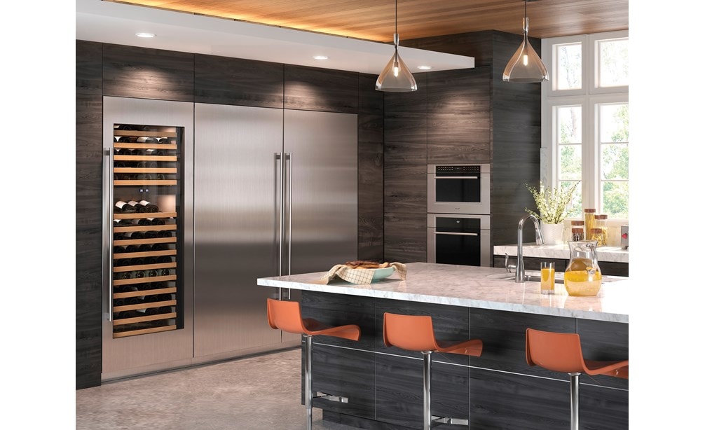 Wolf 30" M Series Transitional Drop-Down Door Microwave Oven (MDD30TM/S/TH) framed in large wood panel cabinetry in contemporary kitchen