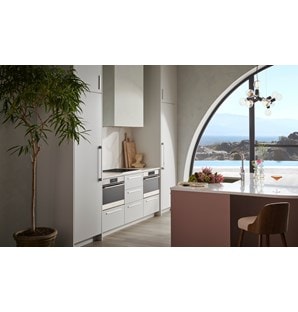 Wolf Convection Steam Oven displayed in minimalist European kitchen featuring white quartz countertops.