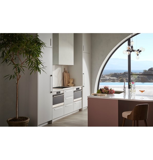 Wolf Convection Steam Oven displayed in minimalist European kitchen featuring white quartz countertops.