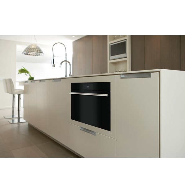 Closeup of undercounter Wolf 30" M Series Contemporary Convection Steam Oven (CSO3050CM/B/T) in a white kitchen island