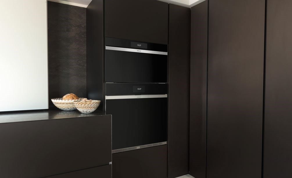 Wolf 30&quot; M Series Contemporary Handleless Steam Oven (CSO3050CM/B) displayed in matte brown custom cabinetry
