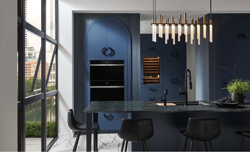 Wolf Convection Steam Oven (CSO3050CM/B) displayed in midnight blue arch kitchen cabinets with rod iron handles.