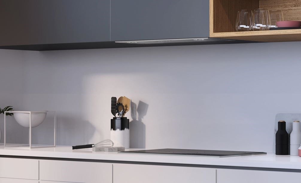 The Wolf 30&quot; Under Cabinet Hood Insert (VU30S) shown in an ultra-modern kitchen design featuring seamless cabinetry
