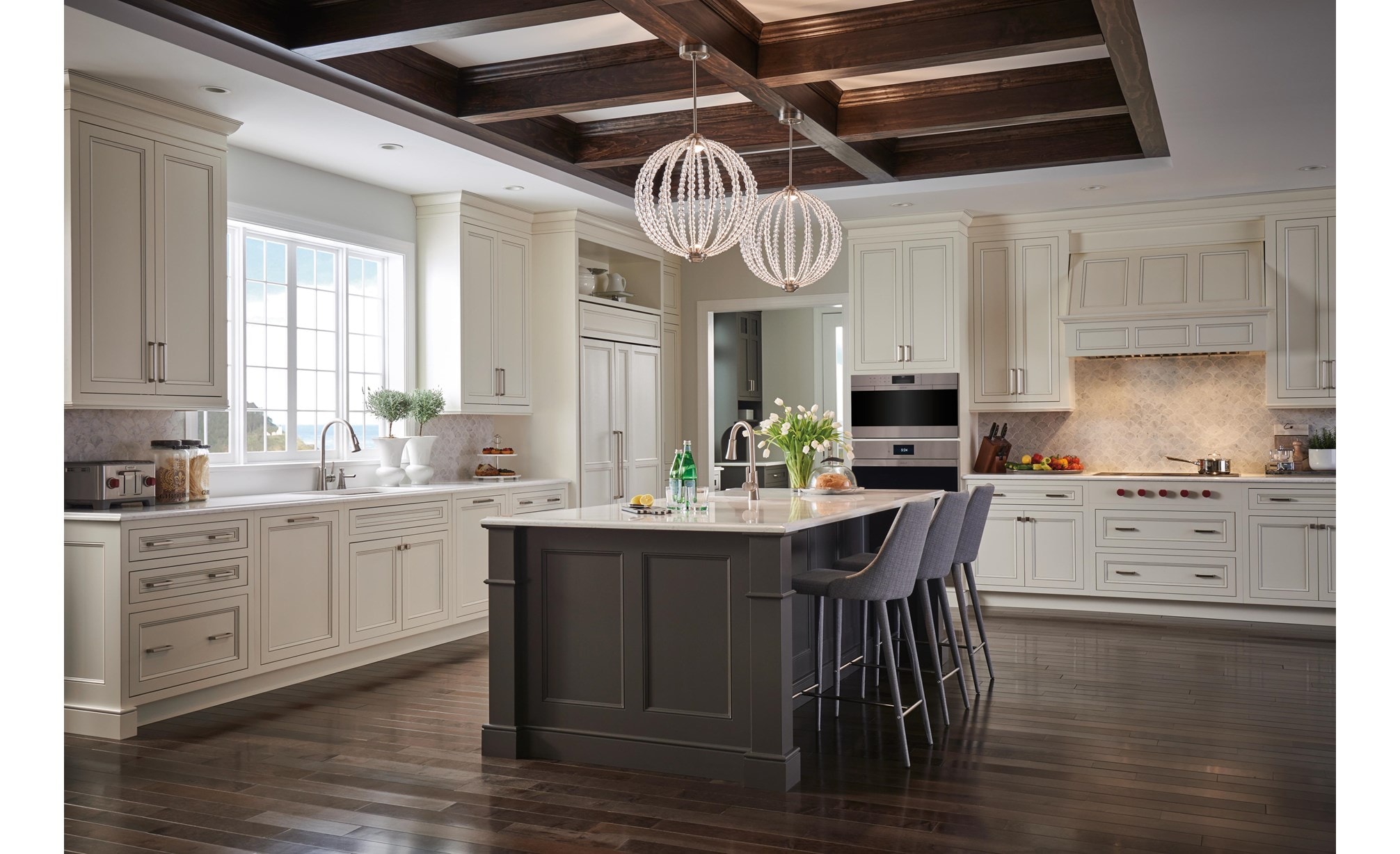 The Wolf 40" Pro Hood Liner 19" Depth (PL401912) shown illuminating cooking area in large open kitchen featuring vintage cabinetry