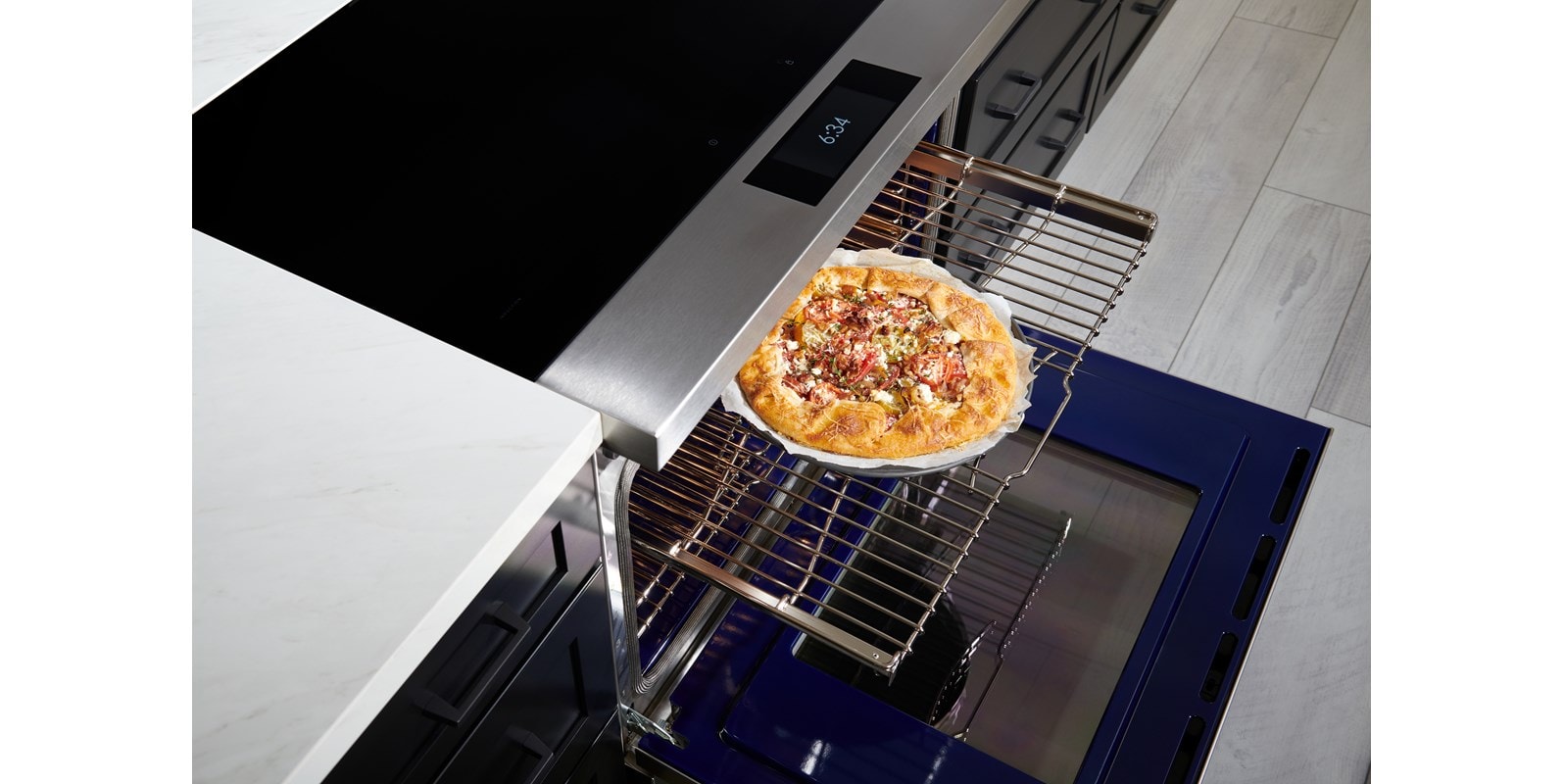 Wolf 36" Induction Range (IR36550/S/T) with Dual VertiFlow™ convection system delivers consistent multi-rack cooking as seen here with a tomato galette.