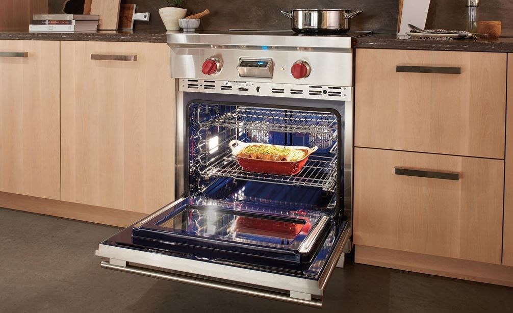 Wolf 30&quot; Transitional Induction Range (IR304TE/S/TH) showing multiple oven racks working in concert thanks to dual fans, each with its own heating element